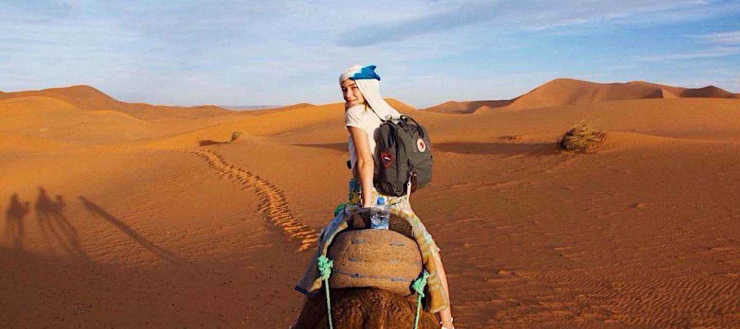 Student On A Camel In The Desert